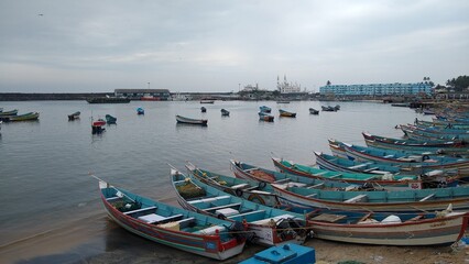 Fototapeta na wymiar Fishing boats in vizhinjam fishing harbor, Thiruvananthapuram, Kerala, seascape view
