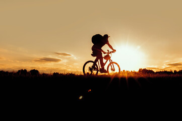 Silhouette of a cyclist on a mountain bike at a beautiful sunset.