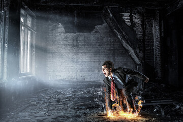 Obraz premium Determined businessman leaving fire trails on asphalt