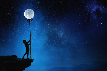 Fototapeta na wymiar Boy holding moon at night