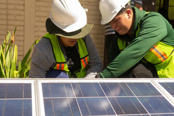 Latino engineer couple working on a solar panel - obrazy, fototapety, plakaty