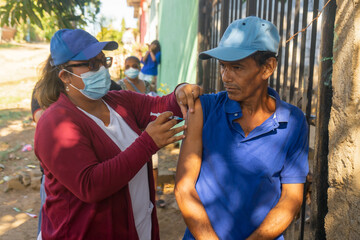 Latino adult man receiving his coronavirus vaccine