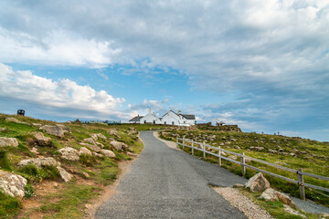 Land's End coastal pathway,looking south towards main tourist area,whitewashed buildings,Cornwall,Southwest England,UK.