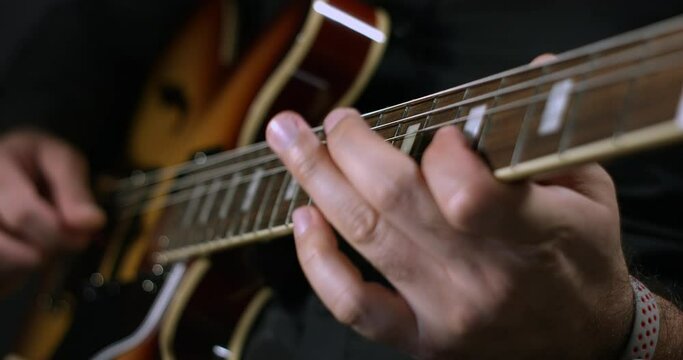 Blues Guitar Player Making Music On Stage. Playing Electric Guitar. Close Up Shot.