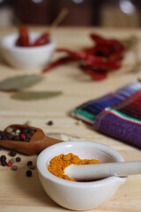 Mortar and Pestle With Turmeric and Chili Peppers