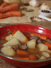 Hearty Beef Stew With Potato and and Carrots on Vintage Burlap potato Bag