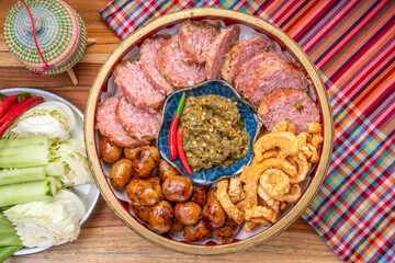 Northern Thai Sausage with Chilli Dips, sour pork and crispy pork rindserved with fresh vegetables and fresh chili, Asian style food. 