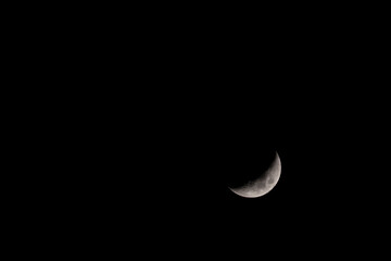 Crescent moon in the dark night sky