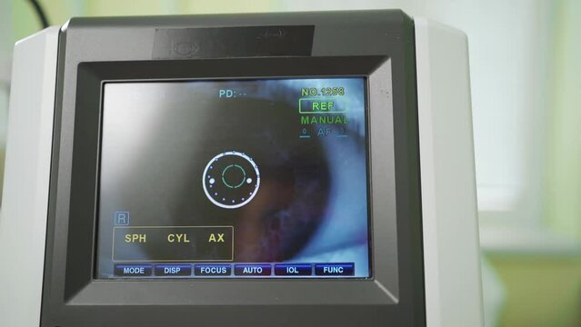 eye on the screen of the autorefractometer. a modern ophthalmic device.