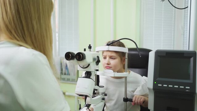 doctor examines girl with slit lamp. equipping ophthalmologist's office.