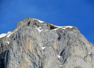 Snow-capped stone alpine peak Moor (2342 m) in the Alpstein mountain range and in Appenzell Alps massif and over the Obertoggenburg valley, Wildhaus - Canton of St. Gallen, Switzerland (Schweiz)