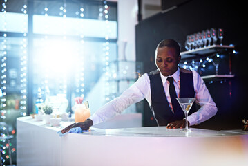 Hes always neat and have a pleasant appearance. Cropped shot of a well-dressed bartender standing...