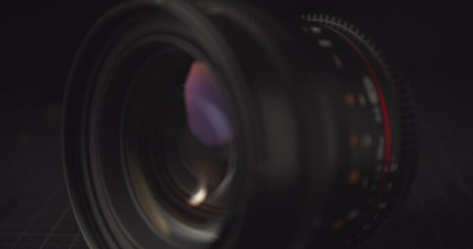 A camera lens coming into focus with a cinematic, mysterious feel.