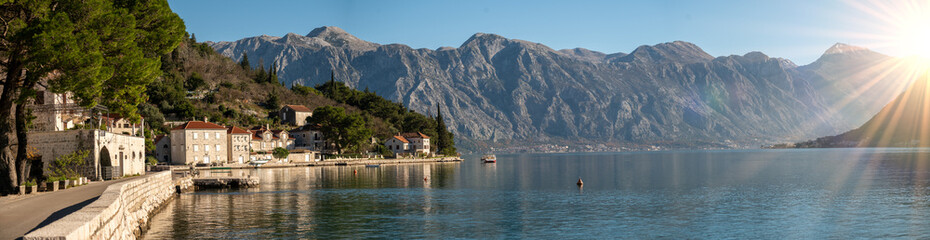 Fototapeta na wymiar Perast, Montenegro and bay of Kotor. Scenic panorama view of historic town Perast at famous Bay of Kotor with blooming flowers on beautiful sunny day with blue sky in summer, panorama
