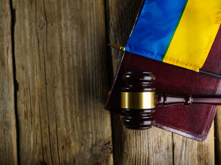 Judge's gavel on the book and the flag of Ukraine.Justice.The Hague court.Stop war and justice.Russian invasion.For news and media