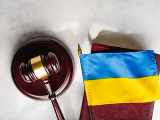 Judge's gavel on the book and the flag of Ukraine.Justice.The Hague court.Stop war and justice.Russian invasion.For news and media