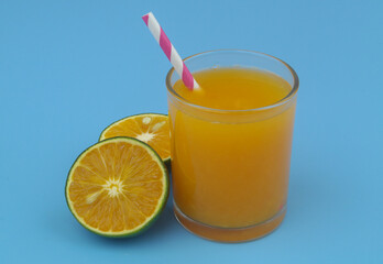 Orange juice with drink straw and orange fruits close up