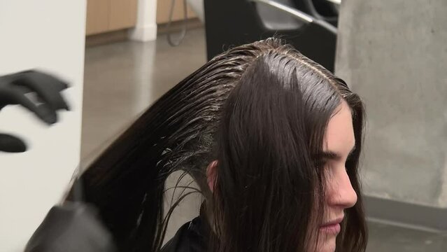 Close Up: Young Woman In Salon Has Roots Touched Up With Hair Colour