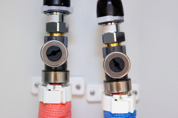 Image of red and blue water pipes under the sink