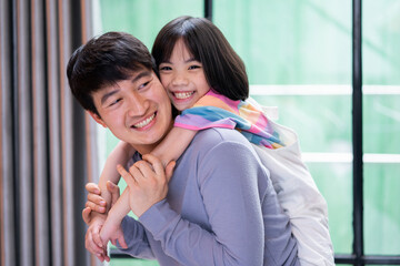 Asian father and daughter at home