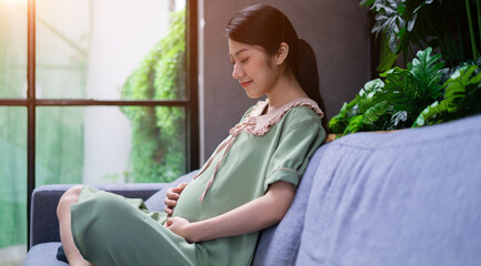 Young Asian woman pregnant relax at home