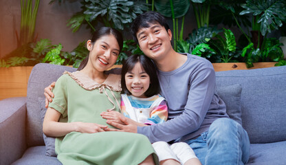 Young Asian family with mother pregnant at home