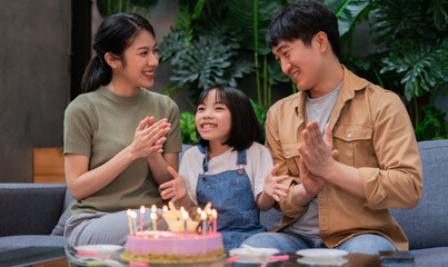 Young Asian couple celebrates their daughter's birthday
