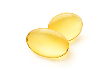 Two Golden color oil in soft gel capsule isolated on white background.
