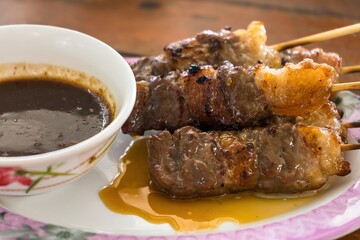 BBQ meat skewered on a charcoal grill.Delicious juicy grilled beef