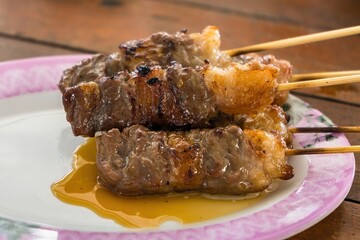 BBQ meat skewered on a charcoal grill.Delicious juicy grilled beef