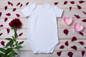 White baby short sleeve bodysuit mockup with pink hearts two pink hearts, maroon peony and petals 