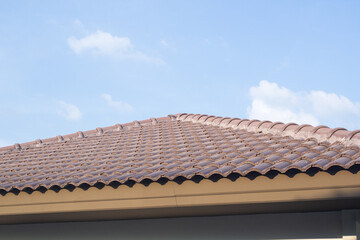 Ceramic roof tiles on the house with blue sky