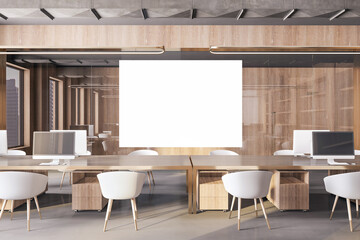 Modern concrete and wooden coworking office interior with empty white mock up frame, equipment, furniture and computer monitors. Design and workplace concept. 3D Rendering.