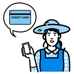 スマートフォンを持ってクレジットカードの説明をしている麦わら帽をかぶった農家の女性
