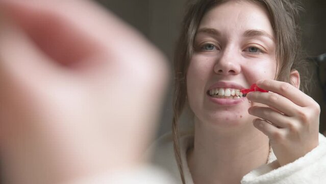 Caucasian Woman uses an interdental brush to clean the interdental spaces. Professional oral care. Correction of bite of teeth