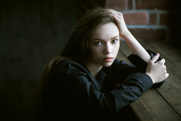 Fototapeta premium girl sitting by window