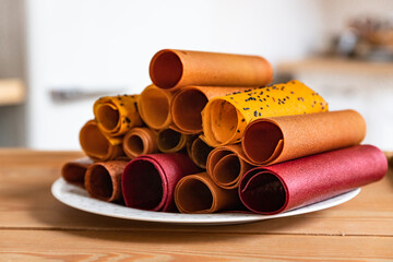 Assorted of fruit and berry marshmallow on white ceramic dish. Pastille fruit rolls. Healthy raw sweets. Diet food and vegan food.