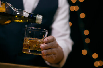 Barman pouring whiskey whiskey glass beautiful night