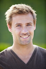 Fototapeta premium Casual charm. A handsome young man smiling broadly at the camera.