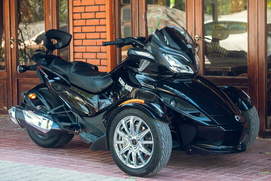 Side, Turkey &ndash; February 16 2022: A  black motorcycle Brp can-am spider stands in a parking against the backdrop of street