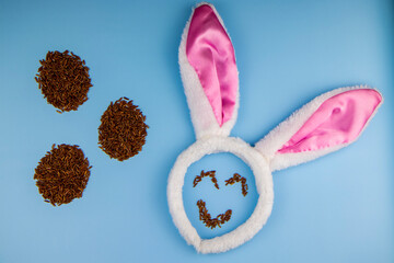 top view of easter bunny ears and smile, unpolished brown rice eggs, proper and healthy eating, holiday diet