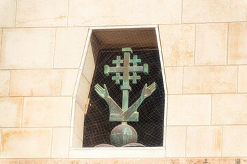 Jerusalem Cross with two hands at The Church of the Annunciation in Nazareth, Israel.