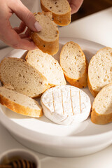 Cooking baked brie with grilled bread