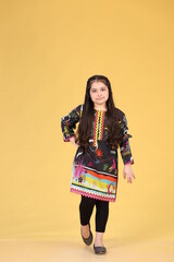 Obraz na płótnie Canvas Pakistani child girl is wearing easter or western dress. Kids girl dress.