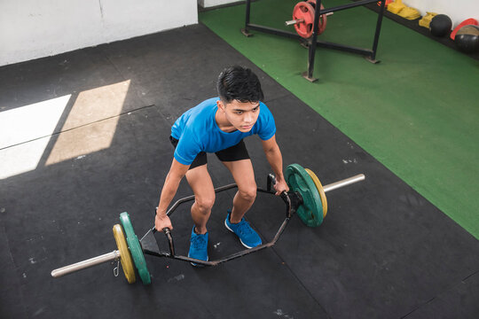 A Young Man Mentally Preparing Himself For A Set Of Trap Bar Deadlifts. Upper Body Workout Session At An Old Hardcore Gym.