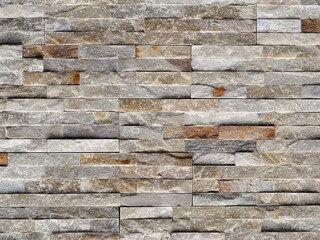 Stone cladding wall made of quartzite tiles, usually used for exterior but  sometimes also for interiors . Close up.