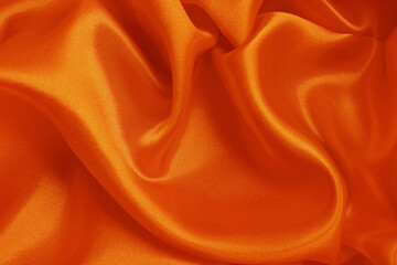 Orange fabric texture background, detail of silk or linen pattern.