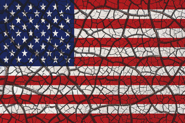 Concept of United States of America hardship times and drought with dry cracked soil and american flag