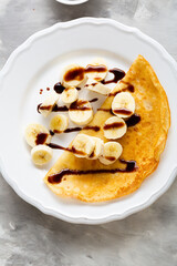 Breakfast crepe with banana chocolate top view