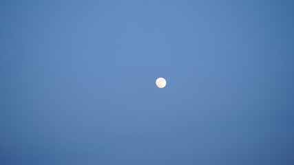 The moon night view with the bright moon in the dark sky at night